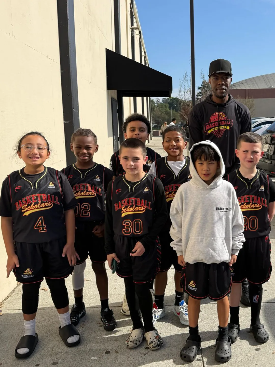 Young Scholars Academy basketball players and their coach outside the Brentwood, CA gym Young Scholars Academy basketball players and their coach outside the Brentwood, CA gym