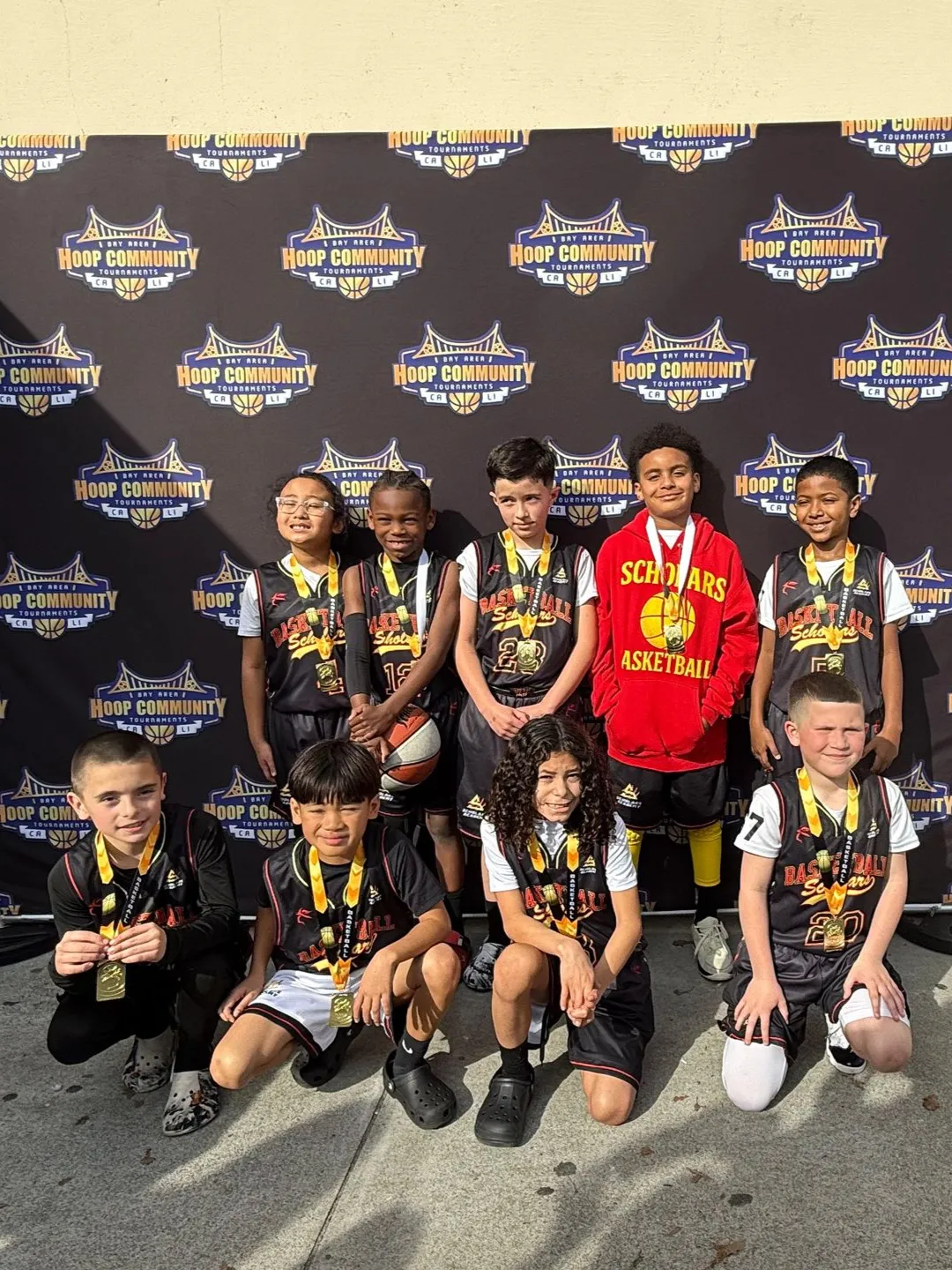 Scholars Academy youth basketball team wearing medals after a Hoop Community tournament in Brentwood, CA